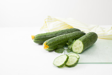 Fresh sliced cucumber with parsley on white background