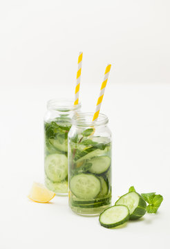 Drink of chopped cucumber and mint on white background