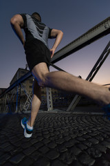 man jogging across the bridge in the city