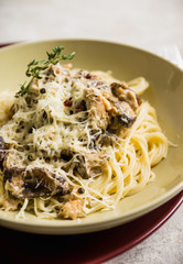 Fresh pasta with meat, mushrooms and herbs. On the rustic wooden background. Selective focus.