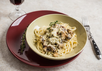 Fresh pasta with meat, mushrooms and herbs. On the rustic wooden background. Selective focus.