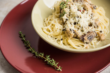 Fresh pasta with meat, mushrooms and herbs. On the rustic wooden background. Selective focus.