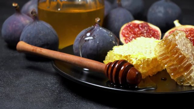 Figs with honey on in the plate on dark concrete background