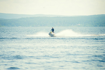 Dona Paula, Goa, India - February 15, 2017: Tourist enjoy water scooter ride in the sea around Dona Paula in Goa, India.