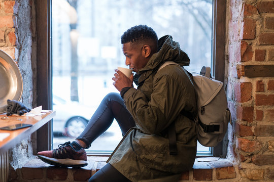 Tourist having warm coffee in cafe
