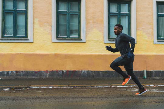 Side view of man running on the street