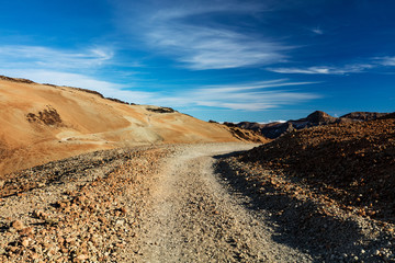 Teide National Park, Tenerife, Canary Islands - Gravel footpath of the Montana Blanca volcanic ascent trail. This scenic hiking path leads up to the 3718 m Teide Peak, the highest peak in Spain.