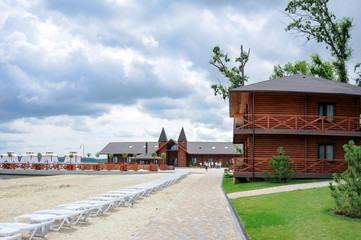 holiday houses on riverbank at recreation center on cloudy summer day