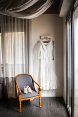 Wedding dress and shoes on a chair