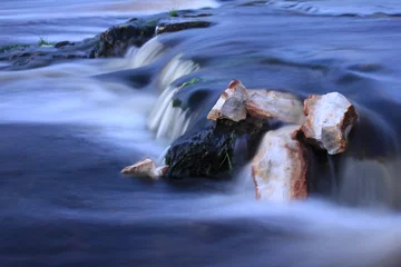 Fototapeten Wald Fluss water flow on long exposure. small waterfall on mountain river stream. river rapids close up.  © Любовь Фомина
