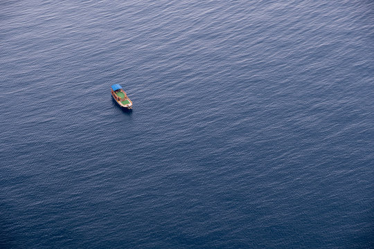 Fototapeta Boat on calm sea water near coast of Turkey