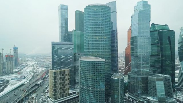 aerial drone shot of skyscraper city architecture during winter