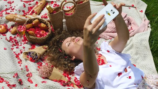  Young Woman Enjoying Provence Picnic And Taking Selfie With Smartphone. Closeup. Top View. 4K. 