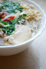Bun Thang - traditional vietnamese rice noodles with shredded chicken, ham and eggs which is garnished by chopped cilantro, spring onion and chili slices.