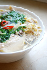 Bun Thang - traditional vietnamese rice noodles with shredded chicken, ham and eggs which is garnished by chopped cilantro, spring onion and chili slices.