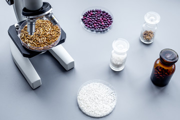 Food analysis. Wheat under the microscope on grey background
