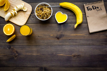 Good morning habits. Eat porridge and fruits and make to do list. Dark wooden background top view copyspace