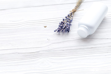 Hypoallergenic bath cosmetics for kids with lavender. Bottle on white wooden background copyspace