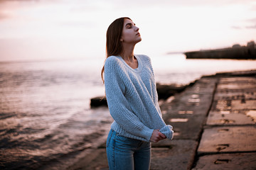 girl in a sweater near the sea