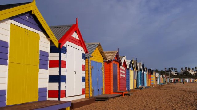 a panning shot of the colorful bathing boxes at brighton beach