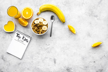 Start the day the right way. Healthy breakfast oatmeal with fruits and planning the day. Grey background top view copyspace
