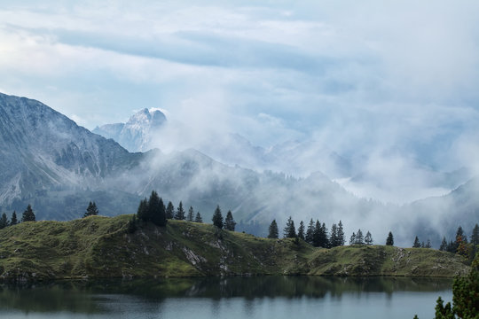 Fototapeta dense fog over mountains after rain
