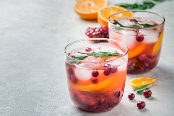 Two glasses with cranberry citrus pomegranate refreshing drinks. Selective focus, copy space. 