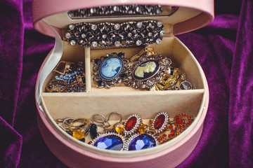 Pink box with vintage jewelry with stones. Concept of femininity, inspiration for gorgeous woman 