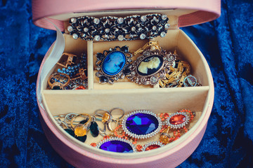 Pink box with vintage jewelry with stones. Concept of femininity, inspiration for gorgeous woman 