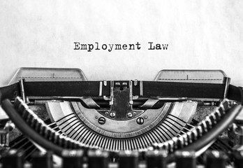 Employment Law word typed words on a vintage typewriter. Close up