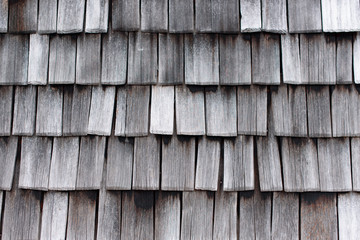 Fototapeta premium wooden tiles, detail of the old weathered wooden roof, wooden texture, abstract pattern, wallpaper background