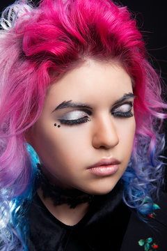 Bright makeup closed eyes girl with clean skin and pink hair close-up