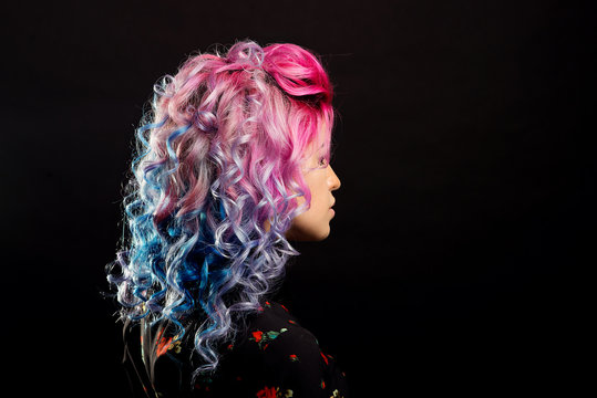 Curly hairstyle for bright pink hair view in profile on a black isolated background
