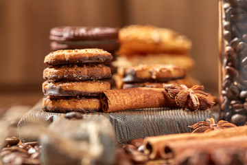 Aroma coffee candy chocolate cookies and spices on the wooden table. Christmas sweets. Dark wooden background. Top view. Close. Closeup.
