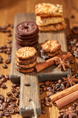 Fototapeta na wymiar Aroma coffee candy chocolate cookies and spices on the wooden table. Christmas sweets. Dark wooden background. Top view. Close. Closeup.
