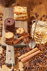 Obraz na płótnie Canvas Aroma coffee candy chocolate cookies and spices on the wooden table. Christmas sweets. Dark wooden background. Top view. Close. Closeup.