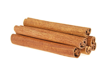 Heap of cinnamon sticks on white background