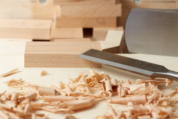 DIY concept. Woodworking and crafts. Chisel. plane and stock on the workbench. Top view. Wooden background.