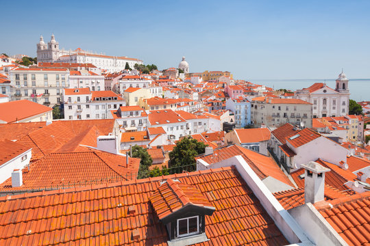 Alfama district in sunny day, red roofs