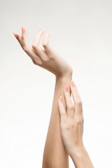 beautiful woman's hands with light pink manicure on the nails