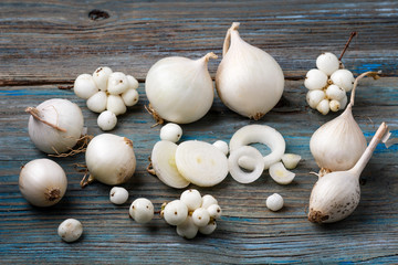 white onion and white berries on a blue wooden background
