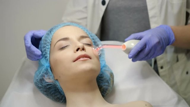 Beautician makes Facial Darsonval Therapy