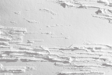 Obraz premium White background with a paint texture. Wall with a pattern of strips of plaster.