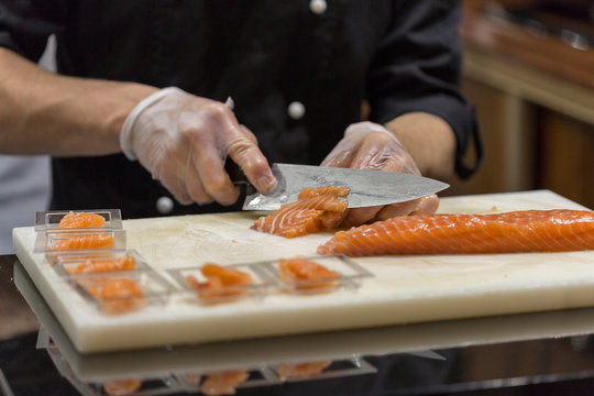 cutting salted salmon in a restaurant