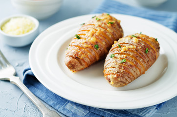 Sliced Baked Parmesan Potatoes with tomatoes and cucumbers