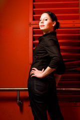 Fototapeta premium Young Woman In Front Of A Red Wall