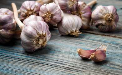 violet garlic on a wooden background