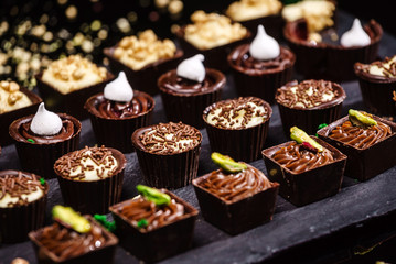 chocolate sweets on black background