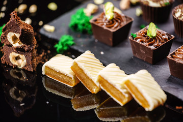 chocolate sweets on black background