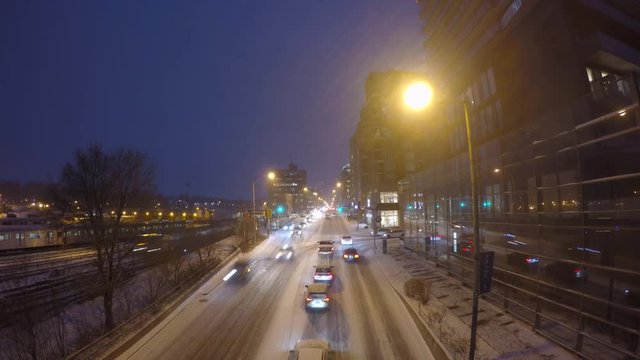 Toronto snow blizzard weather time lapse with cars lining up along Yonge Street and subway train moving on the track on the left